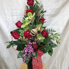 Rose and cymbidium in a vase